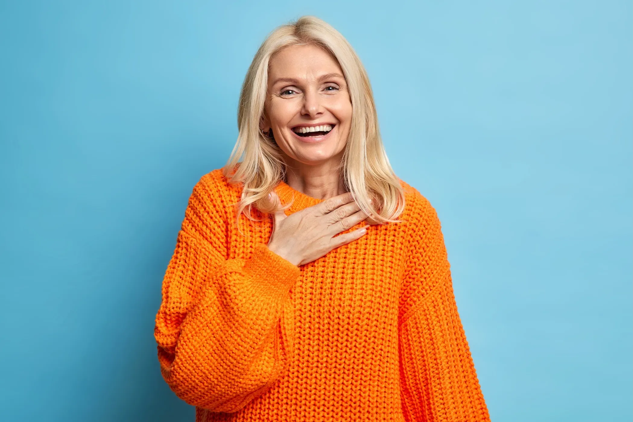 happy woman in an orange sweater