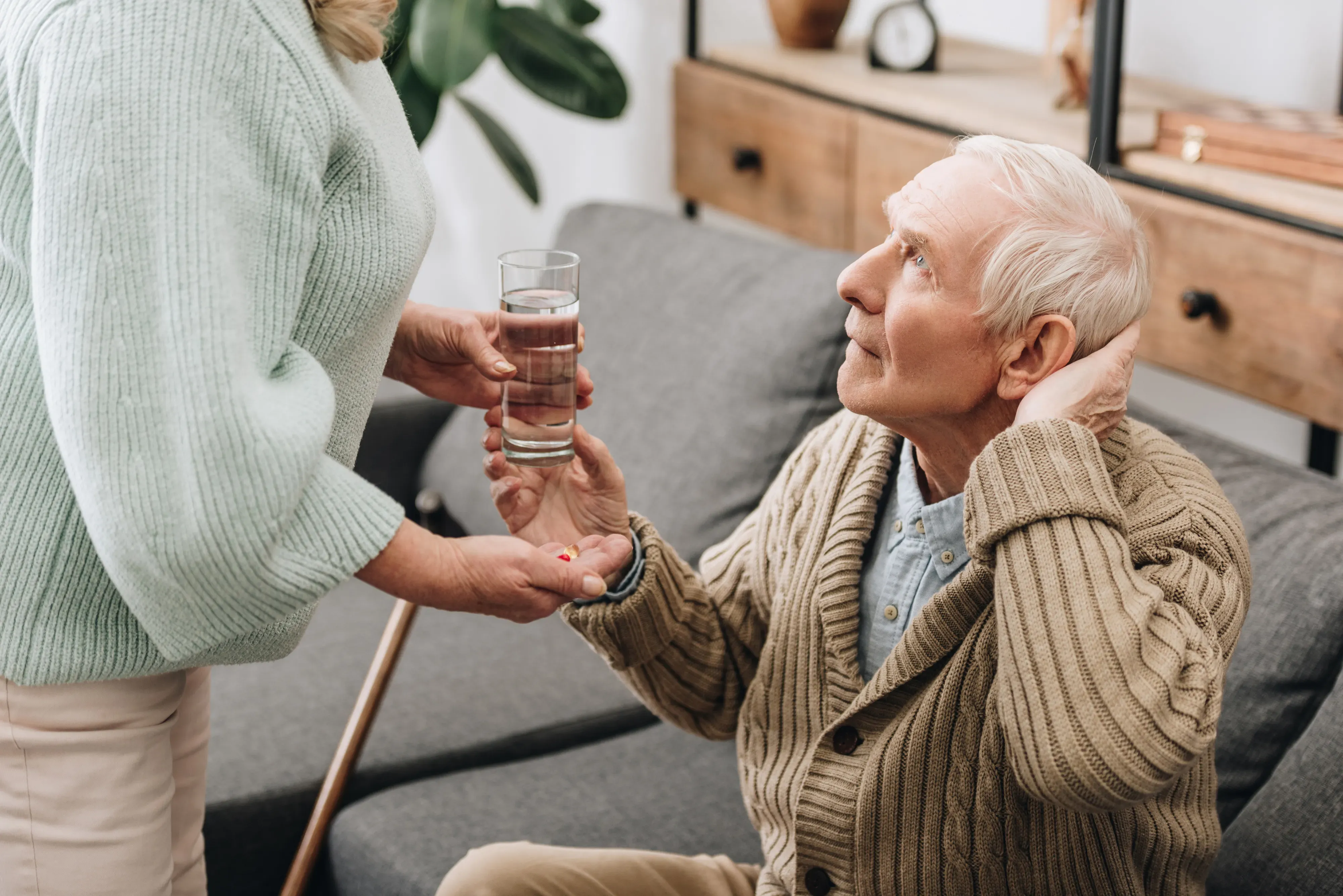 senior man holding back ofhead