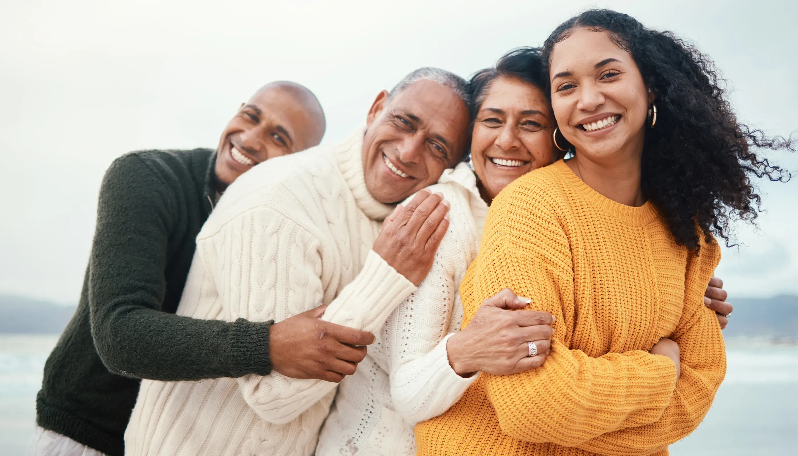 family smiling on the beach