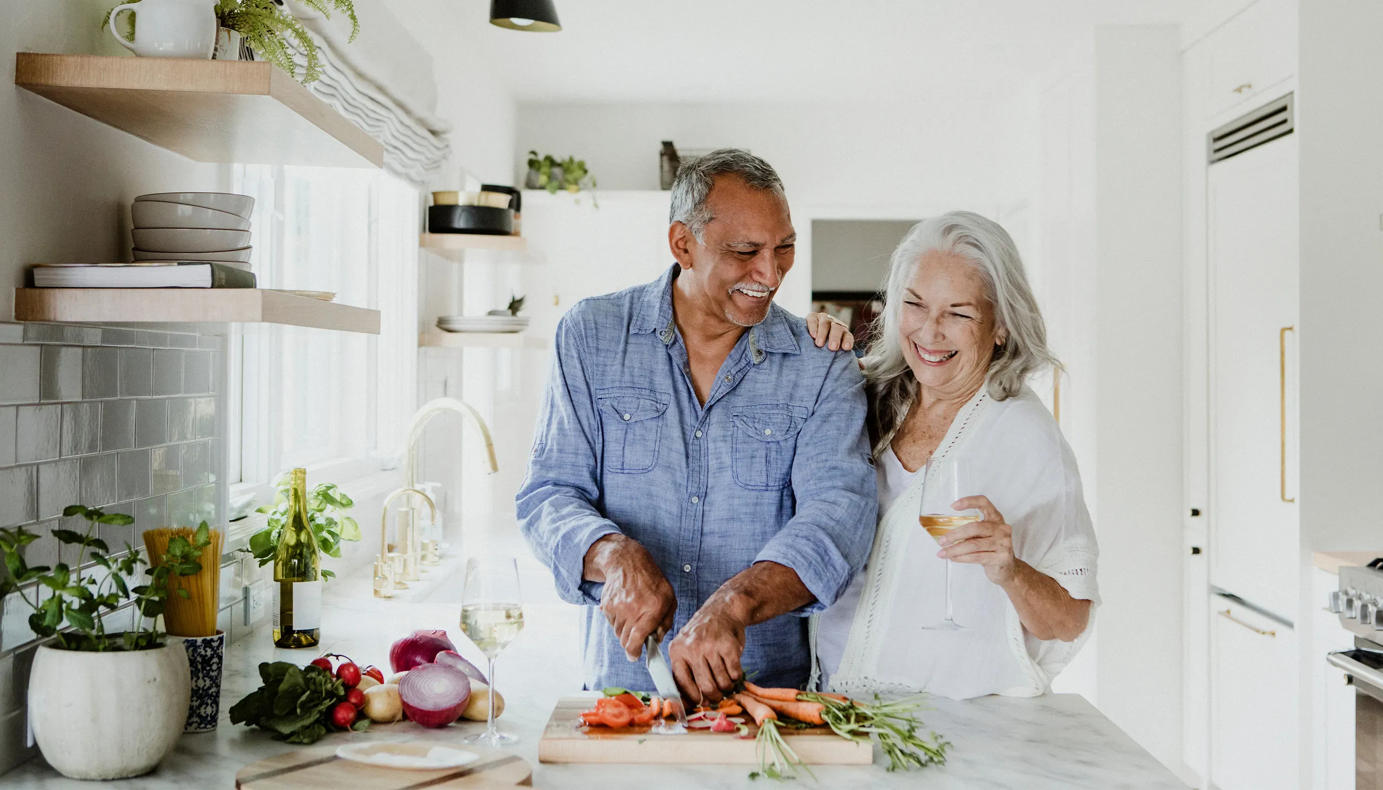 senior couple laughing in kitchen